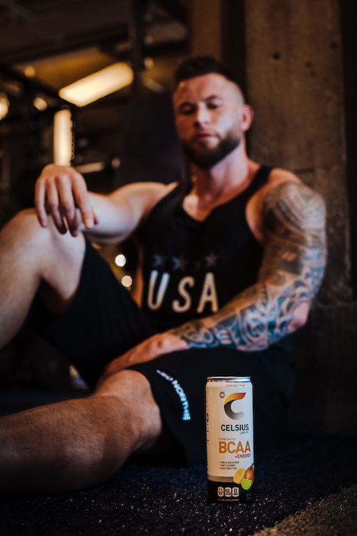 image of a man sitting behind a bcaa celsius