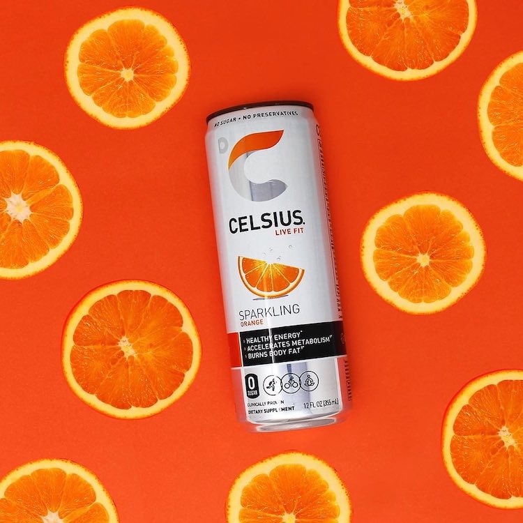 image of sparkling orange celsius can surrounded by